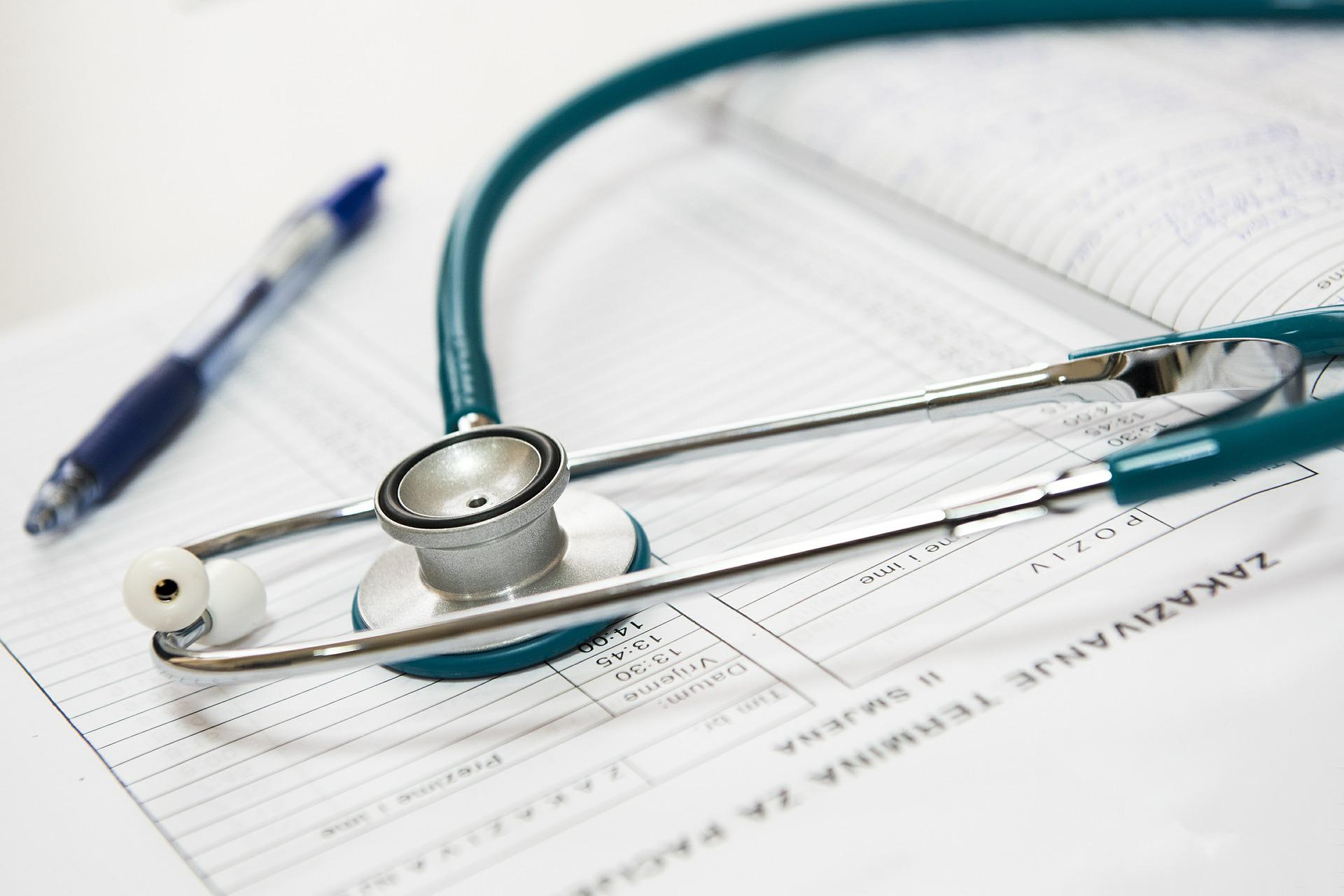 A clip board with a pen and a stethoscope