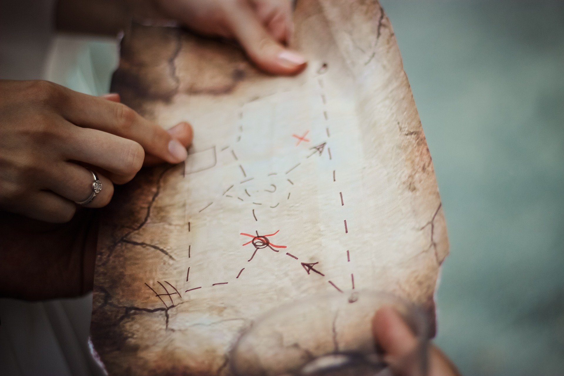 Hands holding an old map