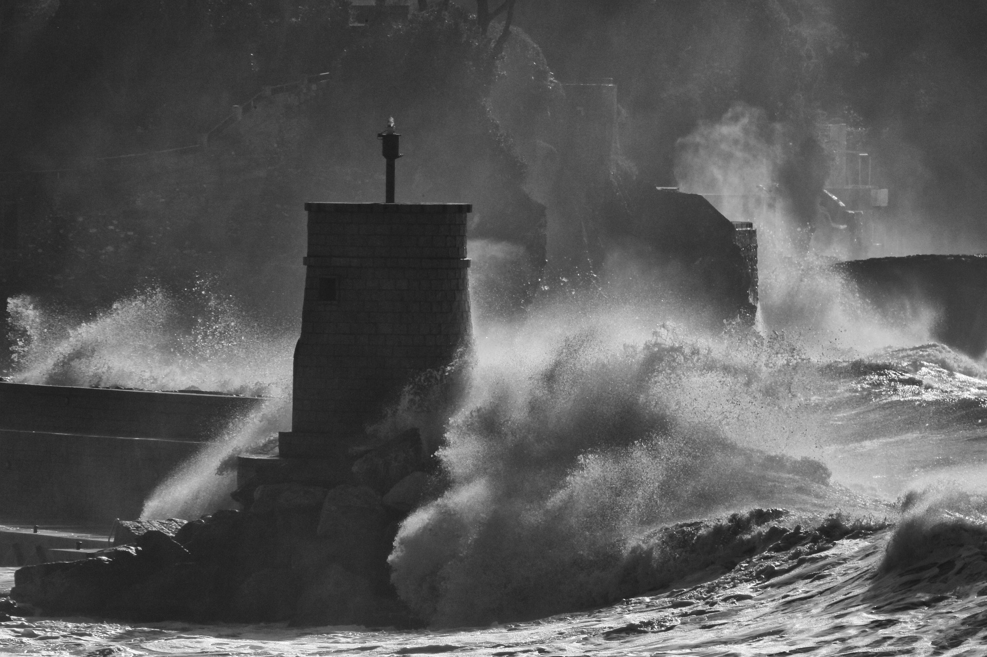 Big waves hitting a sturdy tower.